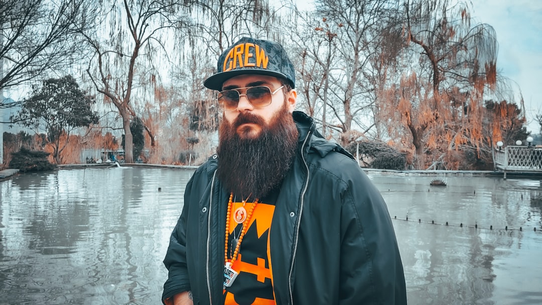 a man with a long beard wearing a hat and sunglasses