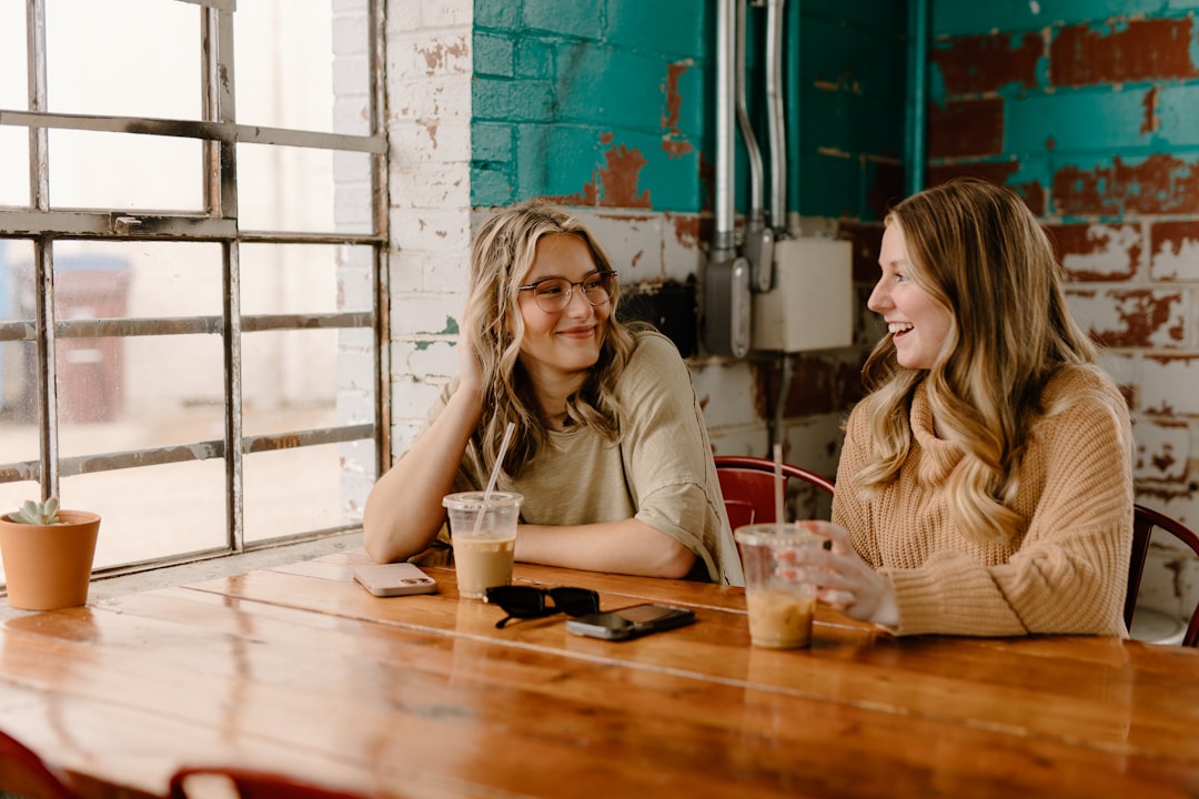 two person holding ceramic mugs with coffee