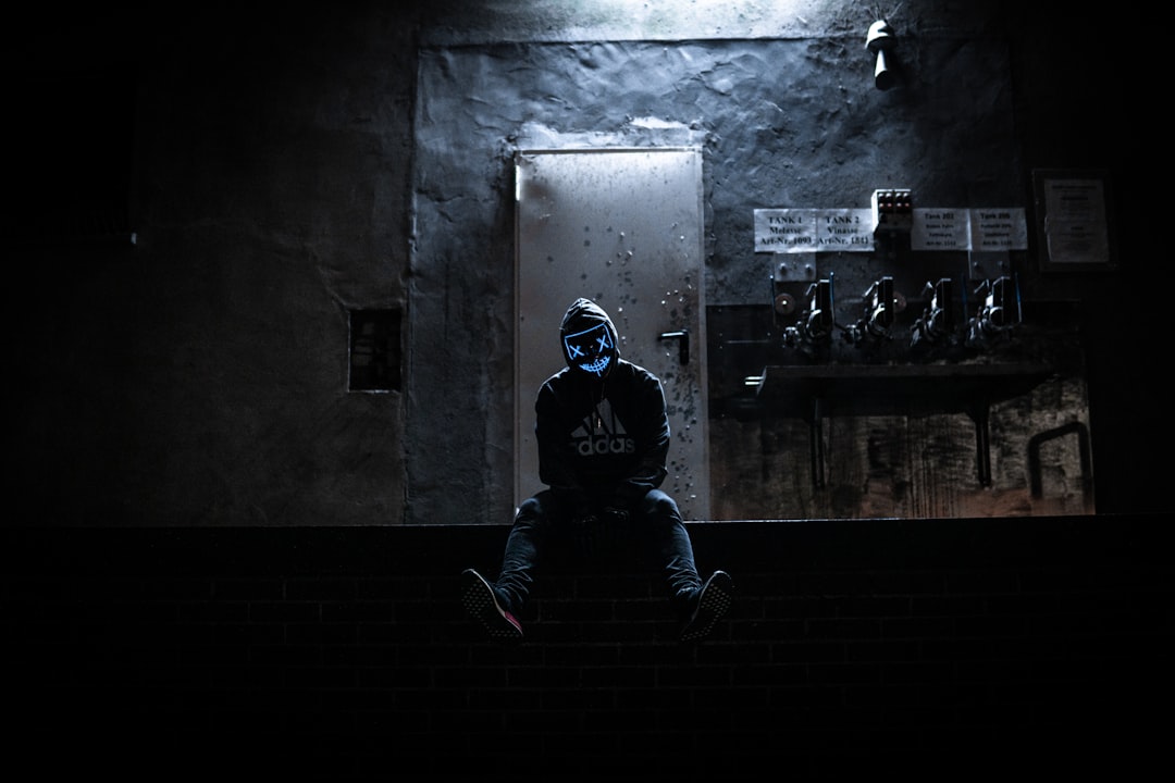 a person wearing a neon mask in a dark room